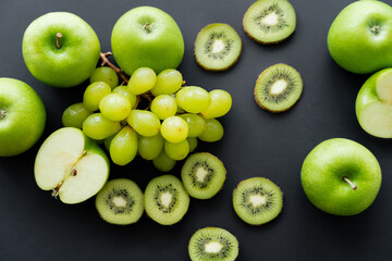 top view of green fresh fruits on black.