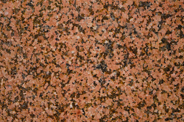Background and texture granite stone with black inclusions.