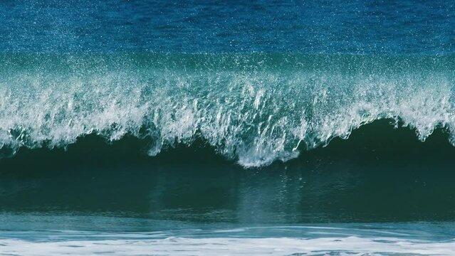Powerful wave breaks over the sandy beach. Atlantic ocean, Brazil