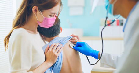 pediatrician examining sick boy