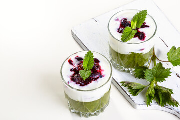 Delicious dessert with a layer of yogurt, nettle smoothie and honeysuckle jam. Dessert is served in...