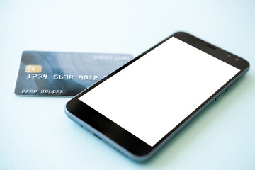 Bank payments. Mobile mockup. Digital technology. Smartphone with white blank screen and plastic credit card isolated blue.