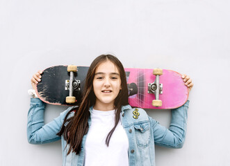 Smiling teenager with a skateboard behind his head © ciprian