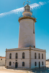 Fototapeta na wymiar The lighthouse of Malaga harbour. Work began in 1816 and was completed a year later, in times of Ferdinand the 7th.