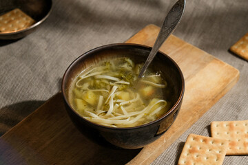 Bowl of vegetable soup on table. Hot meal, healthy vegan dinner.