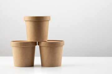 Set of brown crafted paper cup for soup on grey background. Eco package. Zero Waste. Mock up for branding.