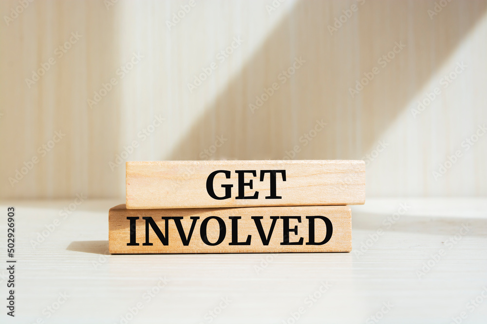Fototapete get involved text concept written on wooden blocks lying on a table