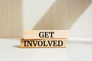 Get involved text concept written on wooden blocks lying on a table