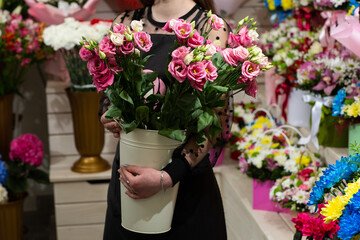 Woman holding Beautiful Eustoma white and pink eustoma on blurred background. Wedding invitation in minimalist style with eustoma.