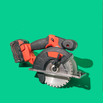 A Brushless Cordless Circular Saw On Beautiful Green Background With Sunny Shadow