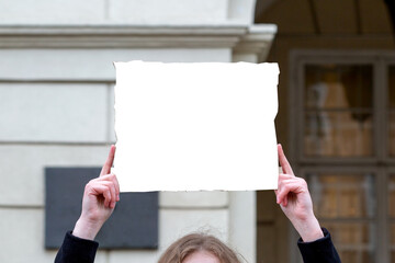 Man's hands hold a blank placard over his head. Mockup, copy space.