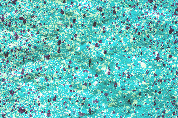 Wall surface with colorful splashes and spots as a background, texture, pattern.