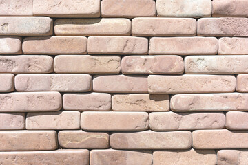 The surface is lined with rectangular brick blocks with rounded corners as a background, texture, pattern.