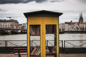 Fototapeta na wymiar Yellow Bohamian bookstore with sea view stormy wheater mood.
