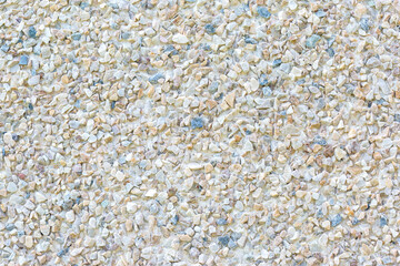 The surface is covered with small colored stones as a background, texture, pattern.