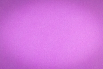 Purple textured paper surface with vignetting as background.