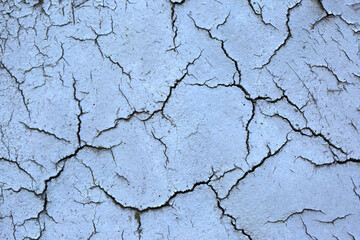 The surface is formed by cracked paint of light purple as a background, texture, pattern.