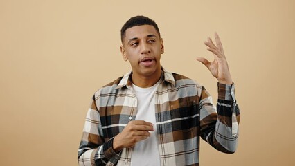 Empty talks concept. Young tired black guy showing blah blah gesture with both hands, expressing boredom of fake news