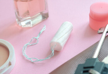 Medical female tampon and other stuff from a women bag. Hygienic white tampon for women. Cotton swab. Menstruation, protection concept.