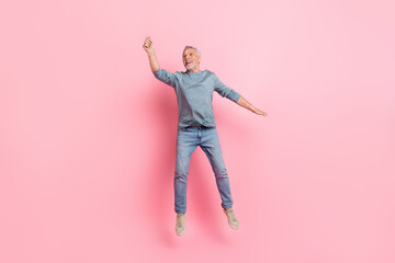 Full length body size view of attractive cheery grey-haired man jumping hanging copy space isolated...