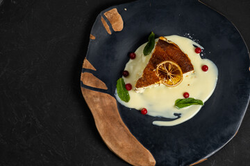 Classic cheesecake on a black background, dessert on a black background in a black plate