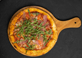 Pizza with prosciutto and cheese. Top view. Free copy space.