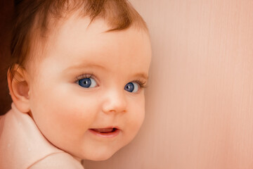 close-up portrait of a smiling baby girl with blue eyes