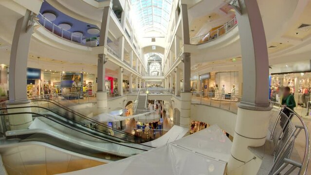 Many shops in multi-level department store or shoping mall timelapse hyperlapse. Escalator between floors