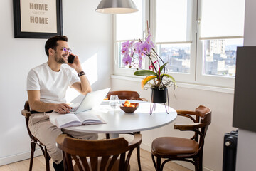 Man working at home using laptop.