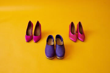 purple and pink shoes on yellow background