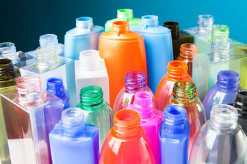 Group of empty coloured plastic bottles and containers for detergents and chemicals. Concept about...