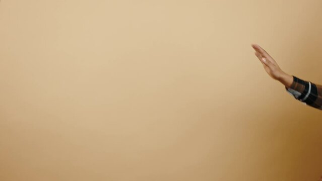 Playful mood. Young positive happy african american guy dancing moon path, moving backward and smiling to camera