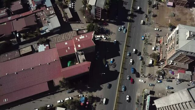 Road traffic aerial reveal of metropolitan cityscape in African modern city. Addis Ababa, Ethiopia