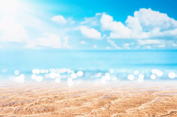 Fototapeta na wymiar Blur tropical beach with bokeh sun light wave abstract background.