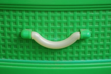 one white handle on a green plastic kitchen cabinet