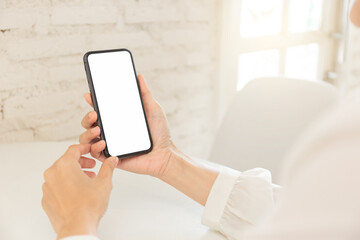cell phone blank white screen mockup.hand holding texting using mobile on desk at office.background empty space for advertise.work people contact marketing business,technology