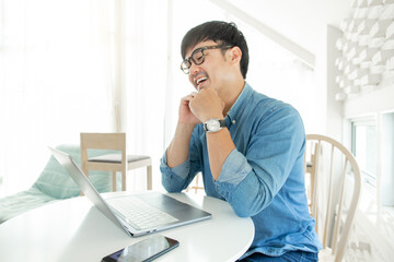 Fototapeta premium asian man work using computer hand typing laptop keyboard contact us.student study learning education online.adult professional people chatting search at office.concept for technology device business