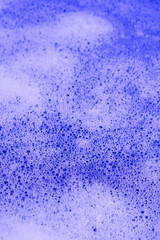 background purple  foamy water close-up. abstract bubbles in white color 