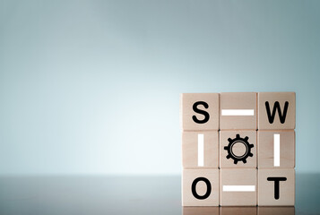 SWOT analysis Concept.,SWOT word and Gear icon on wooden cube with copyspace.
