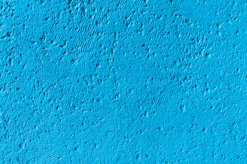 Fototapeta na wymiar Photo of an old weathered concrete wall tinted blue to use great as a background