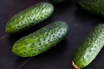 Cucumbers on a black background. Vegetables in a salad