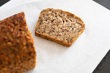 bread with seeds and a piece of bread on a white background