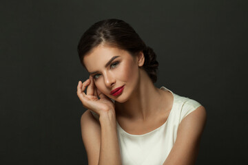 Portrait of young model with bright impressive red lips, studio photo shoot