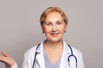 Confident friendly mature female doctor portrait