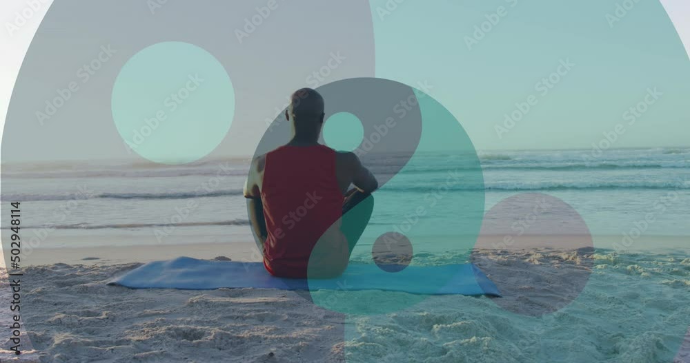 Sticker Animation of ying yang symbol over senior african american man sitting on sunny beach