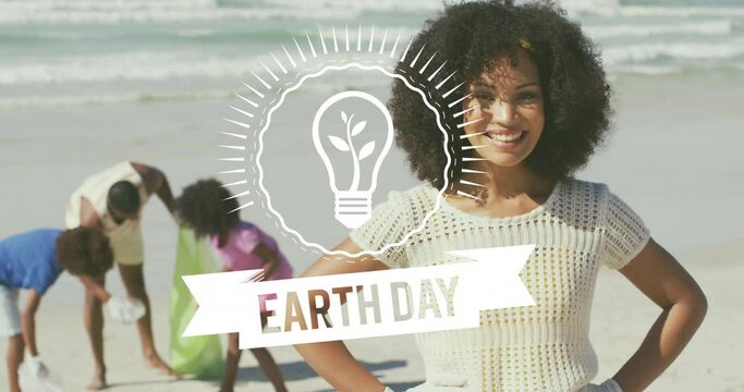 Animation of earth day text over happy african american family picking waste on sunny beach