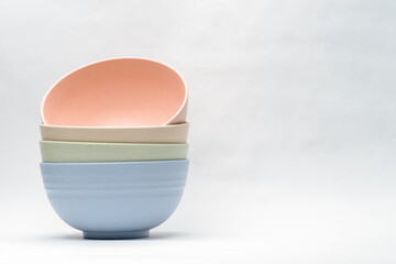 selection of pastel colored diningware bowls stacked