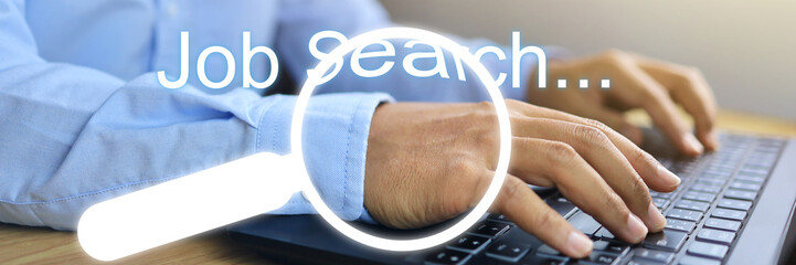A man who has just graduated is unemployed is searching for an online job search from an entrepreneur or a private company or a recruiter. closeup shot of hand and magnifying glass job search concept. - obrazy, fototapety, plakaty