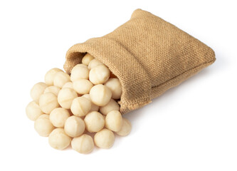 Shelled Macadamia nuts in the sack, isolated on white background.