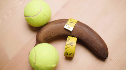Measuring manhood girth of black banana with balls